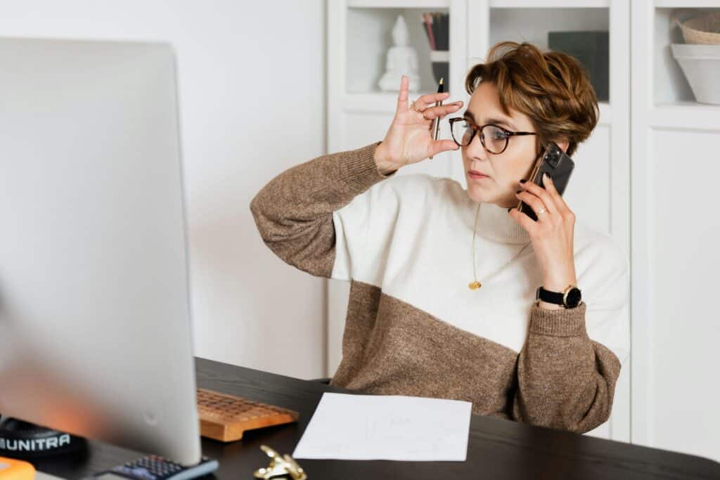 A woman on the phone is speaking with the professional movers