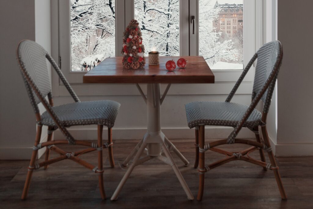 A coffee table with holiday decor by the window in winter